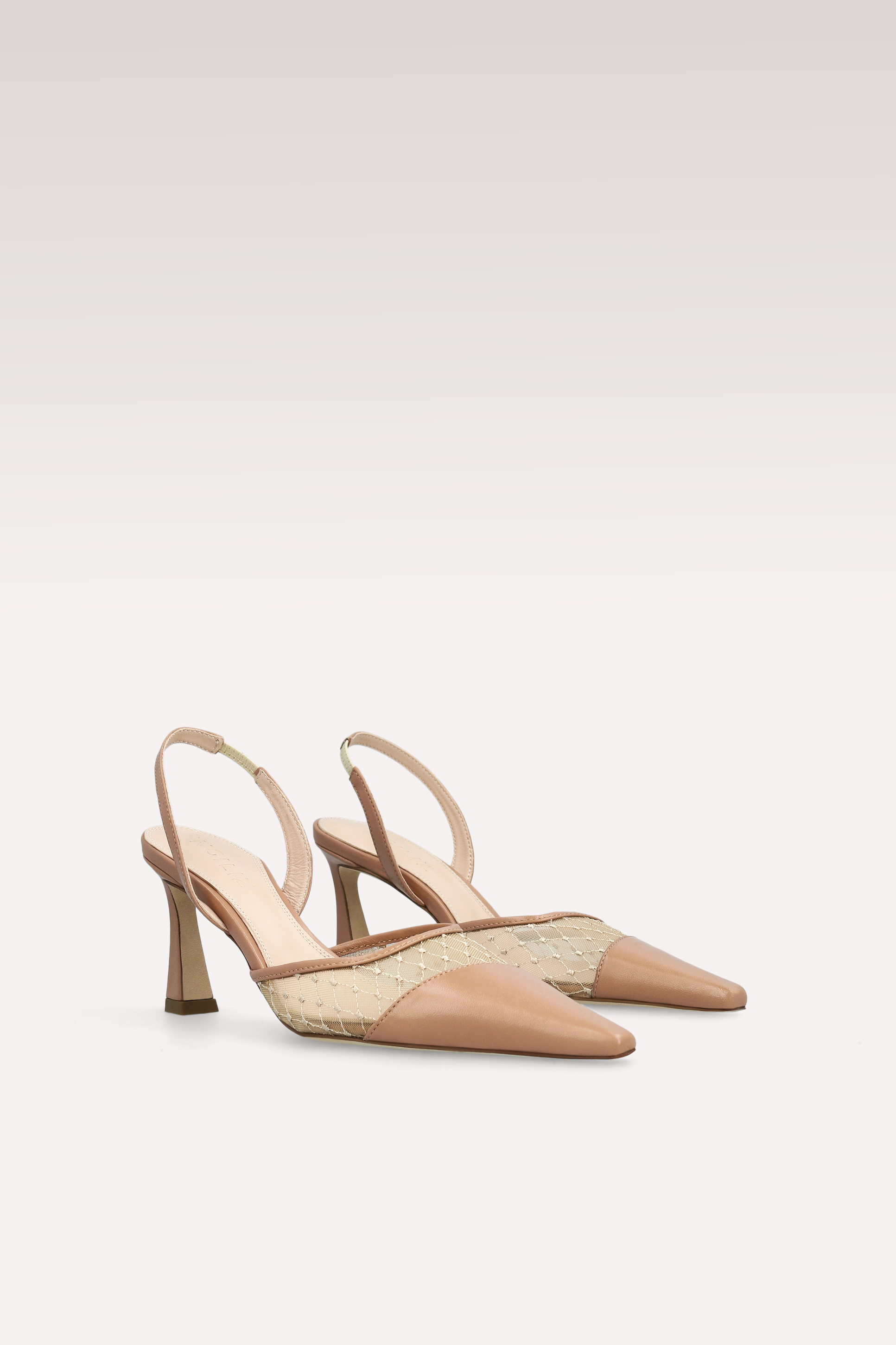 Pair of beige slingback shoes on a light gray background